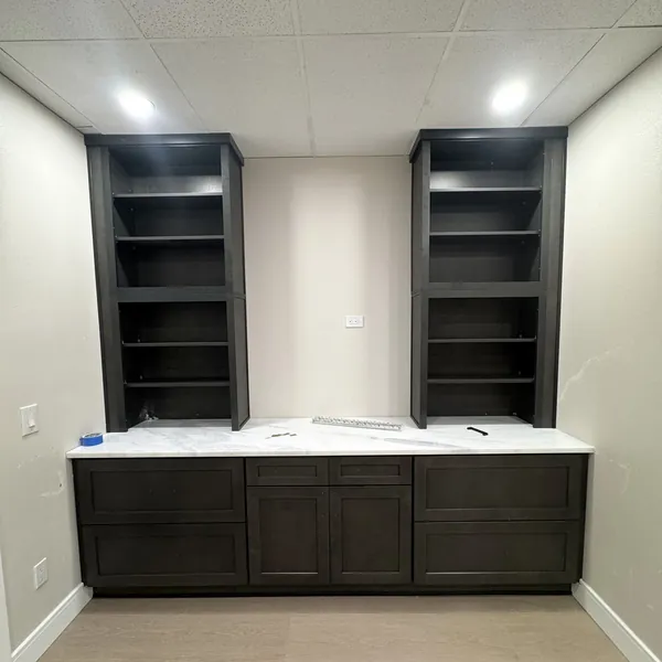 Two open shelving towers over dark shaker base cabinets with a white stone top, Tampa Bay