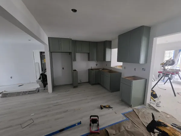 Green shaker kitchen cabinets during installation, before the countertops, Tampa Bay